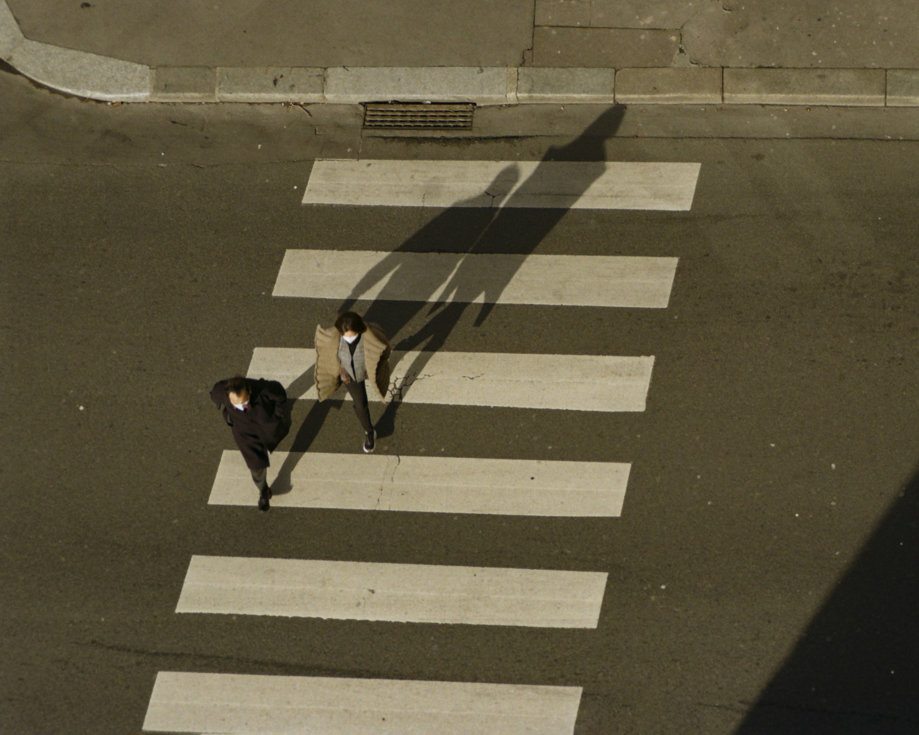 A cyclist and pedestrians crossing a city street